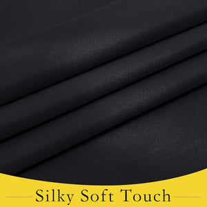 Close-up of dark black fabric with a subtle sheen, folded to reveal its silky soft texture.