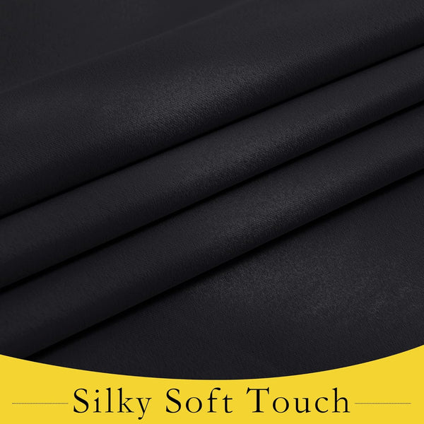 Close-up of dark black fabric with a subtle sheen, folded to reveal its silky soft texture.