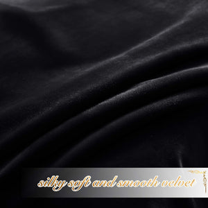 Close-up of luxurious black silky soft velvet fabric with gentle drapes and a subtle sheen.