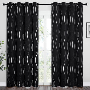 Black blackout curtains with a shiny silver wavy pattern and grommet top, hanging on a rod.