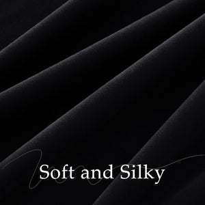 Close-up of soft, silky black fabric with subtle sheen and elegant drapes.