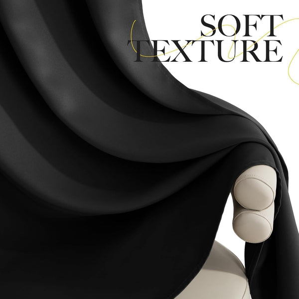 Close-up of smooth, soft black fabric, draped over a beige armrest, highlighting its luxurious texture.