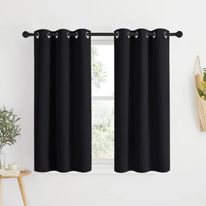 Two black solid grommet top curtains hanging on a black rod, covering a window.