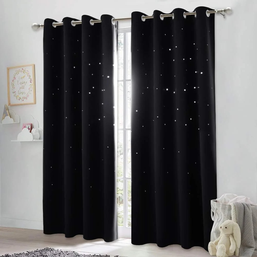 Black blackout curtains with star cutout lights and silver grommets in a nursery room