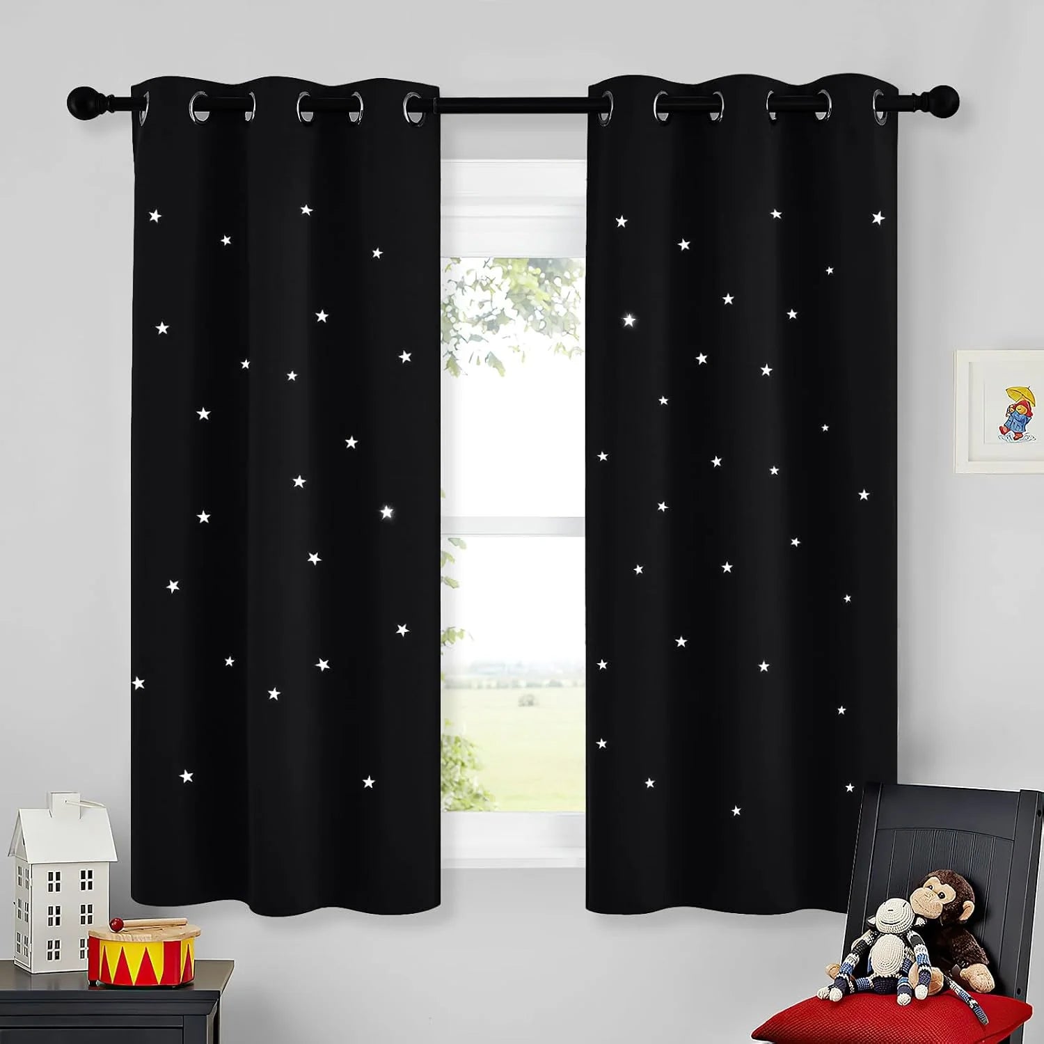 Black kids blackout curtains with white star cutouts on grommet top window panels