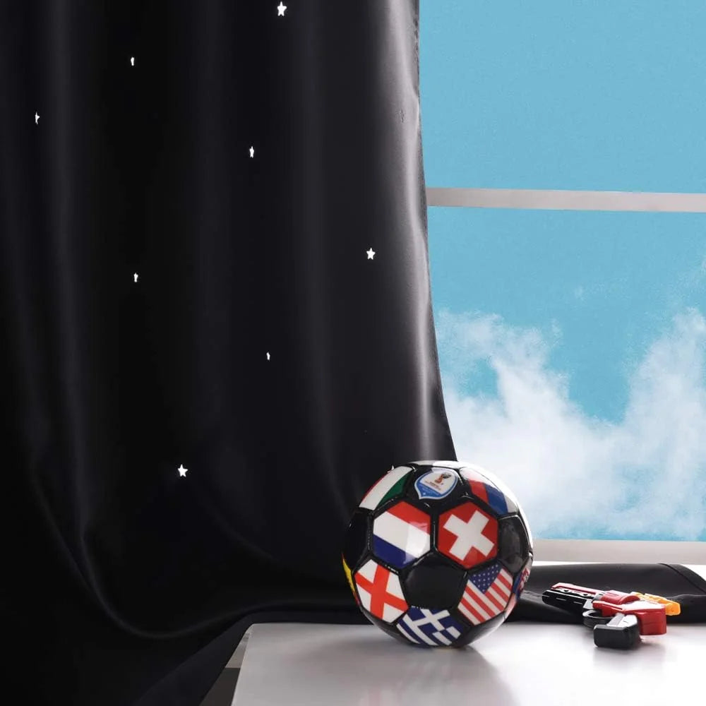 Black star print curtain beside a bright window with a soccer ball on a table