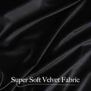 Close-up of luxuriously draped black super soft velvet fabric showing its smooth texture and subtle sheen.