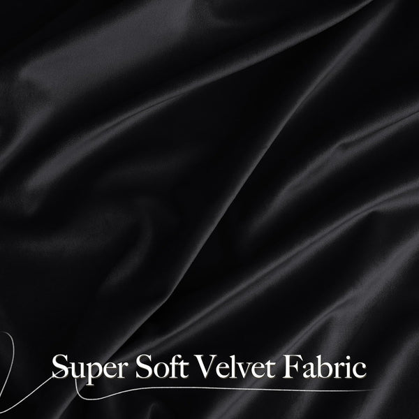 Close-up of luxuriously draped black super soft velvet fabric showing its smooth texture and subtle sheen.
