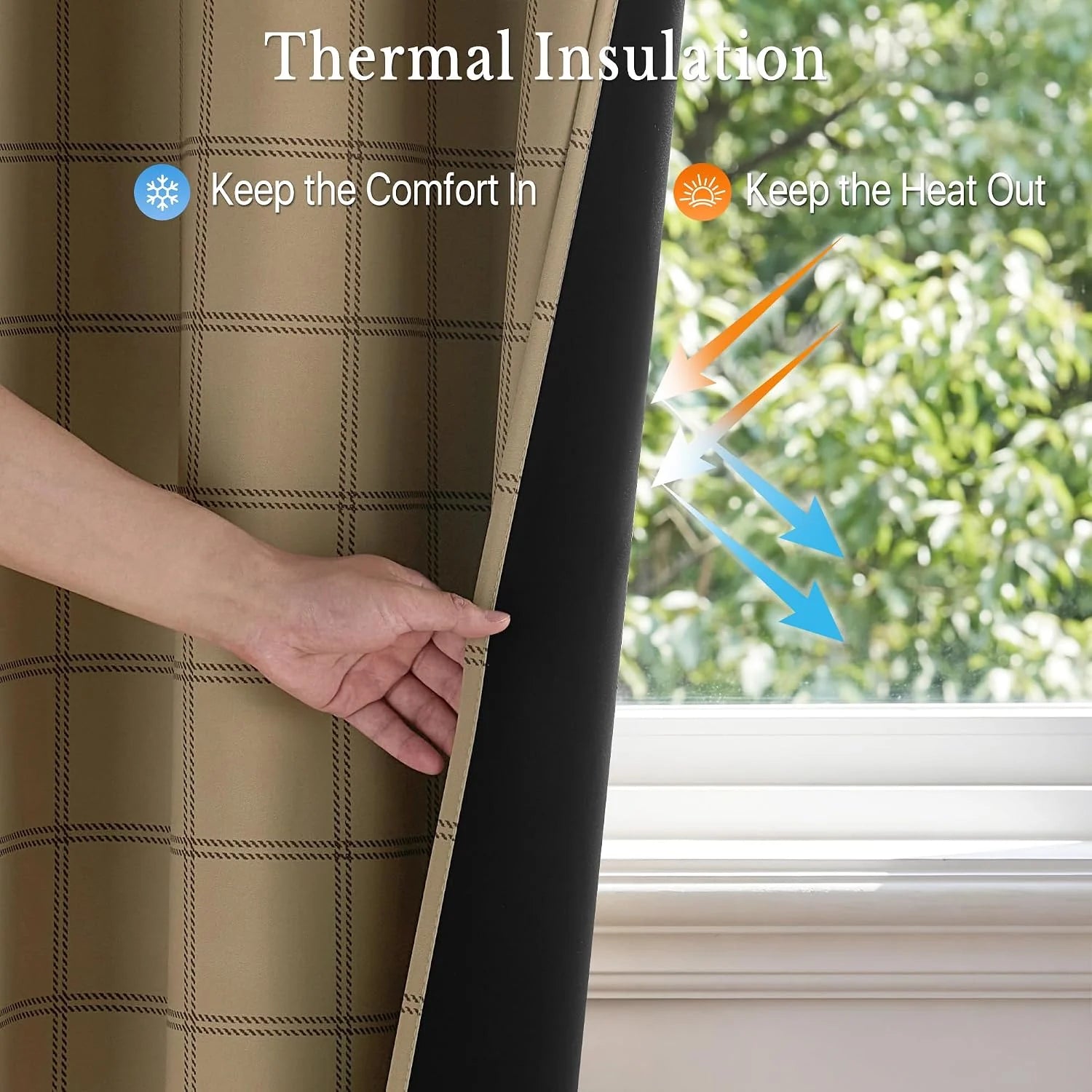 Hand holding black thermal blackout curtain with tan plaid lining by a window