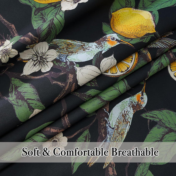 Black fabric with vibrant tropical bird, lemon, and white flower print. Appears soft.