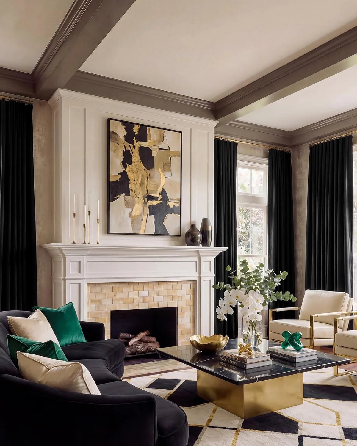 Black velvet curtains framing tall windows in an elegant living room with fireplace