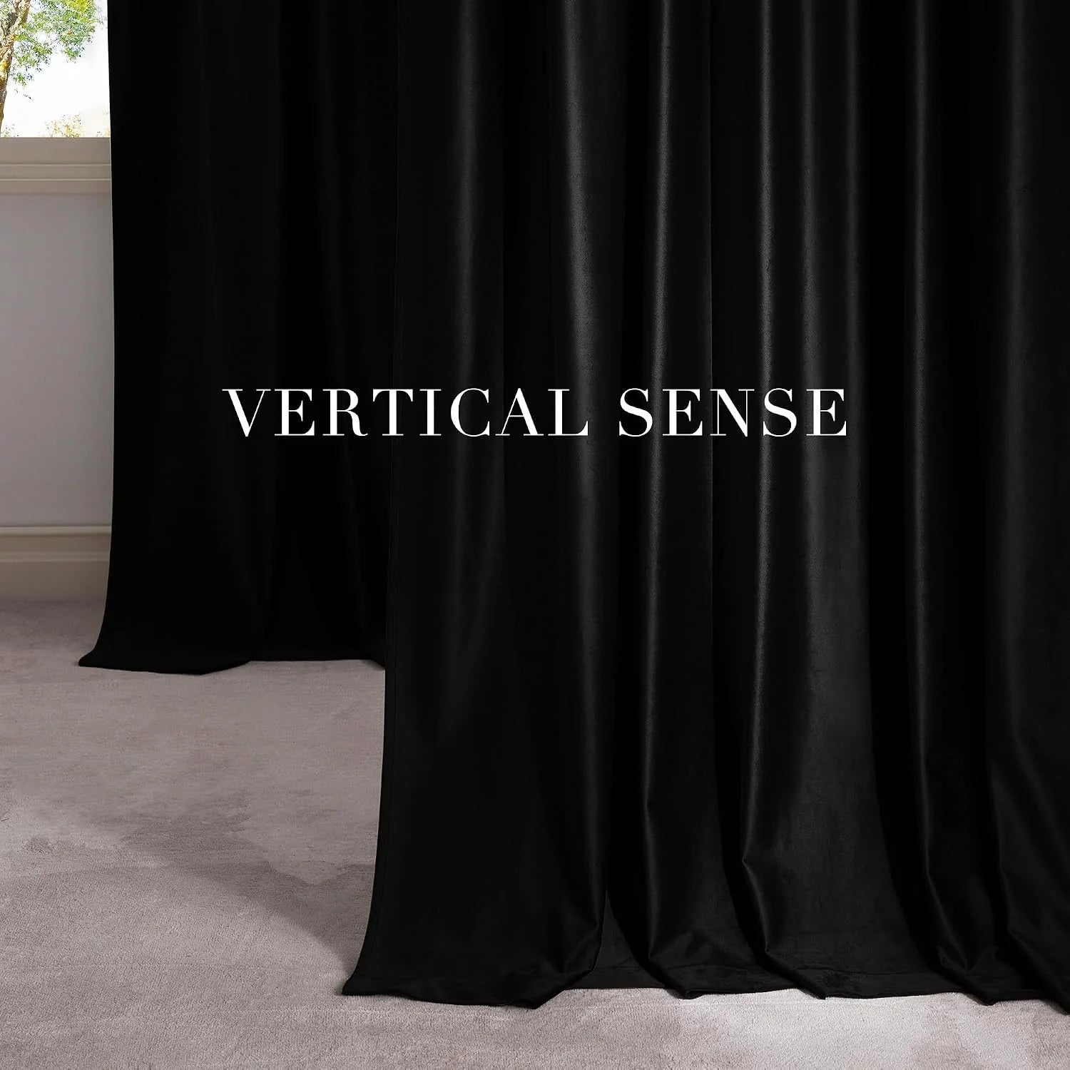 Black velvet drapes pooling on a light carpet beside a modern window