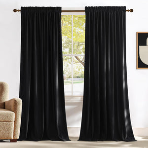 Black velvet pencil pleat curtains hanging on a bronze rod, ideal for room darkening.