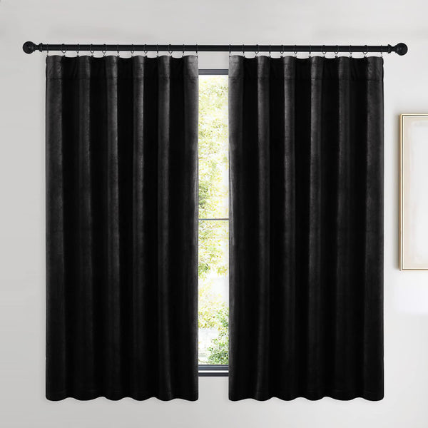 Rich black velvet window curtains with a soft texture, hung on a black ring-top rod.