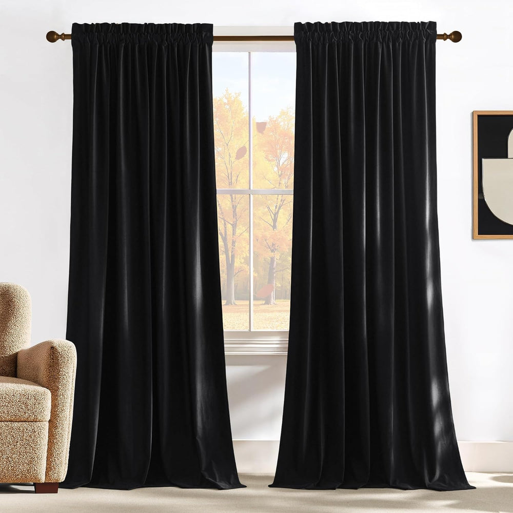 Pair of plush black velvet curtains with a gathered rod pocket top, hanging in a light-filled room.