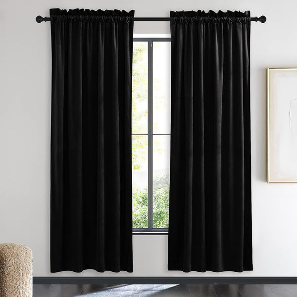 Elegant black velvet curtains with rod pocket top, draped on a dark rod in a modern room.