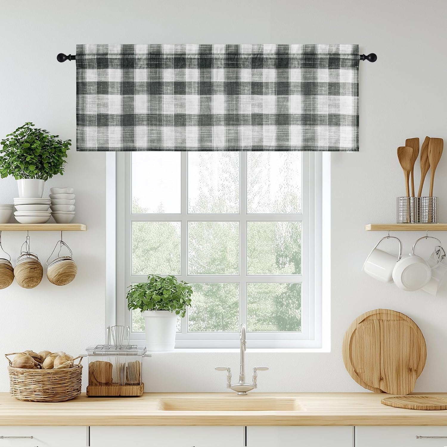 Distressed black and white buffalo check window valance hangs on a rod in a bright kitchen.