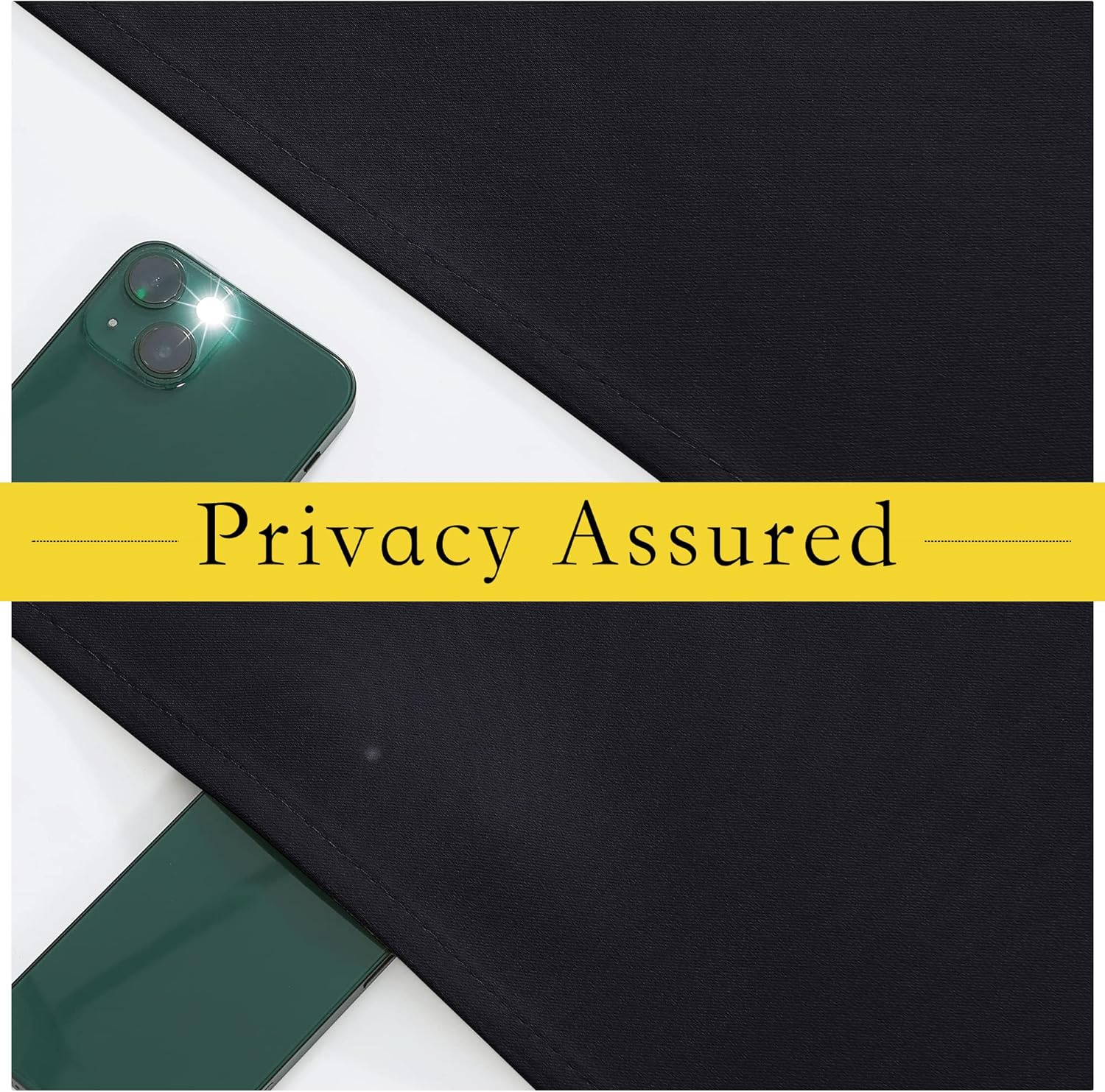 Close-up of black blackout curtain fabric blocking light, with a smartphone flash visible behind it, emphasizing privacy.