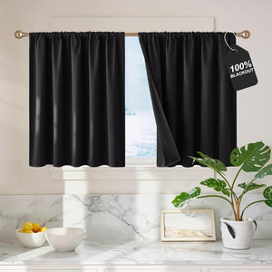 Black 100% blackout tier curtains with rod pocket top installed on a kitchen window.