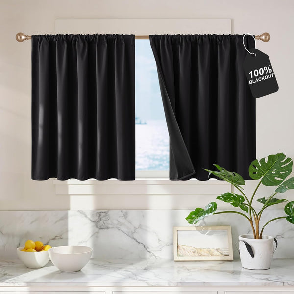 Black 100% blackout tier curtains with rod pocket top installed on a kitchen window.
