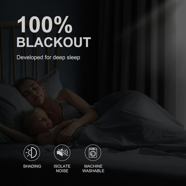 Sleeping mother and child in dark room with 100% blackout curtains, offering shading and noise isolation.