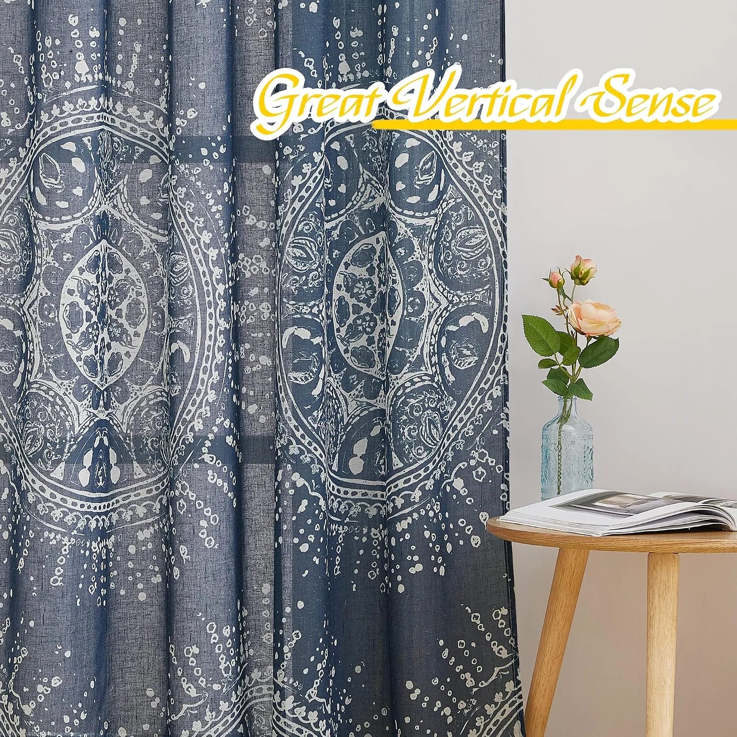Blue boho printed curtain panel beside a wooden side table with vase and flowers