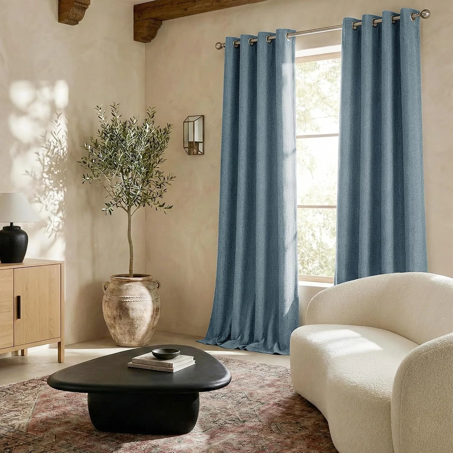 Dusty blue linen-look grommet curtains in a warm neutral modern living room