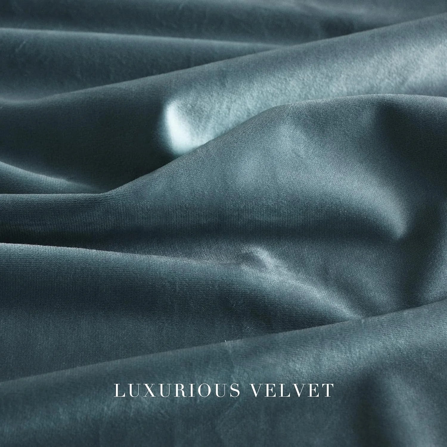 Close-up of soft blue luxury velvet fabric with smooth folds and subtle sheen