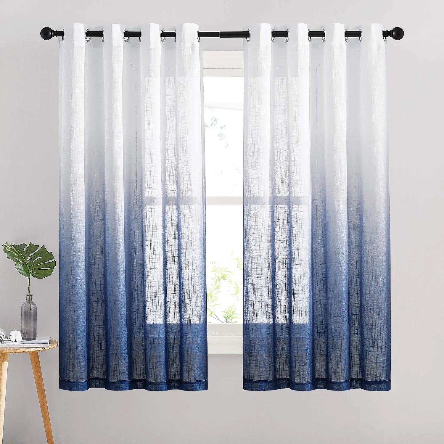 White to navy blue ombre sheer curtains with grommet top on a black rod