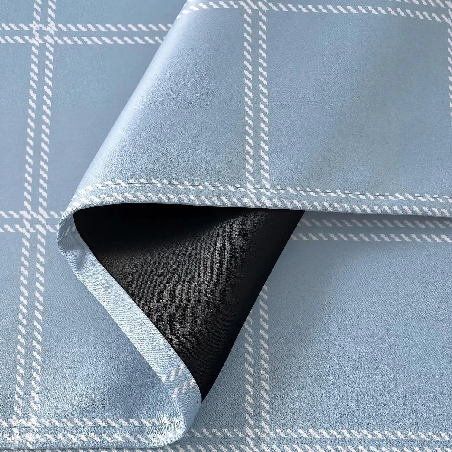 Light blue plaid curtain fabric with white grid pattern and black blackout backing