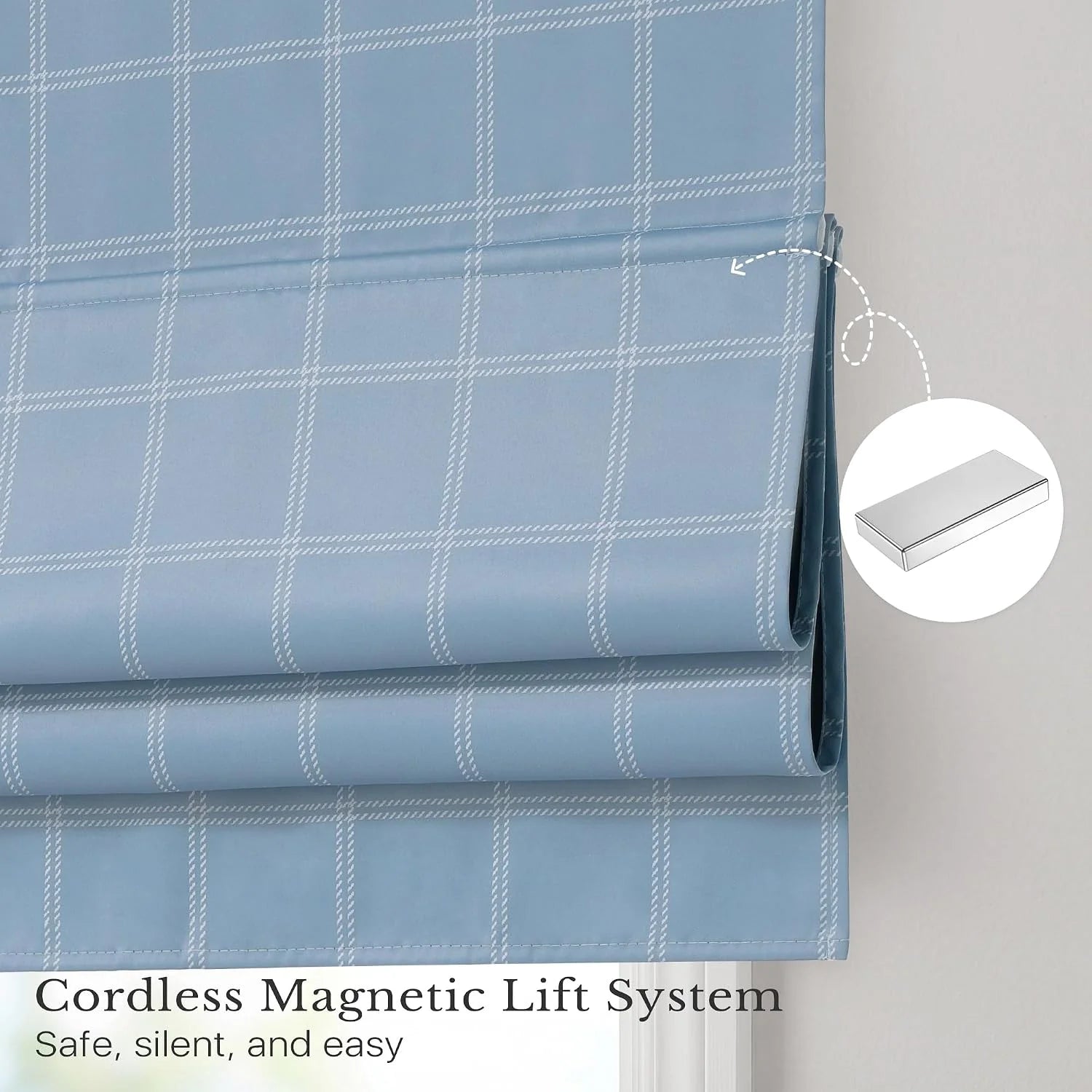 Blue plaid cordless Roman shade with magnetic lift system on a window