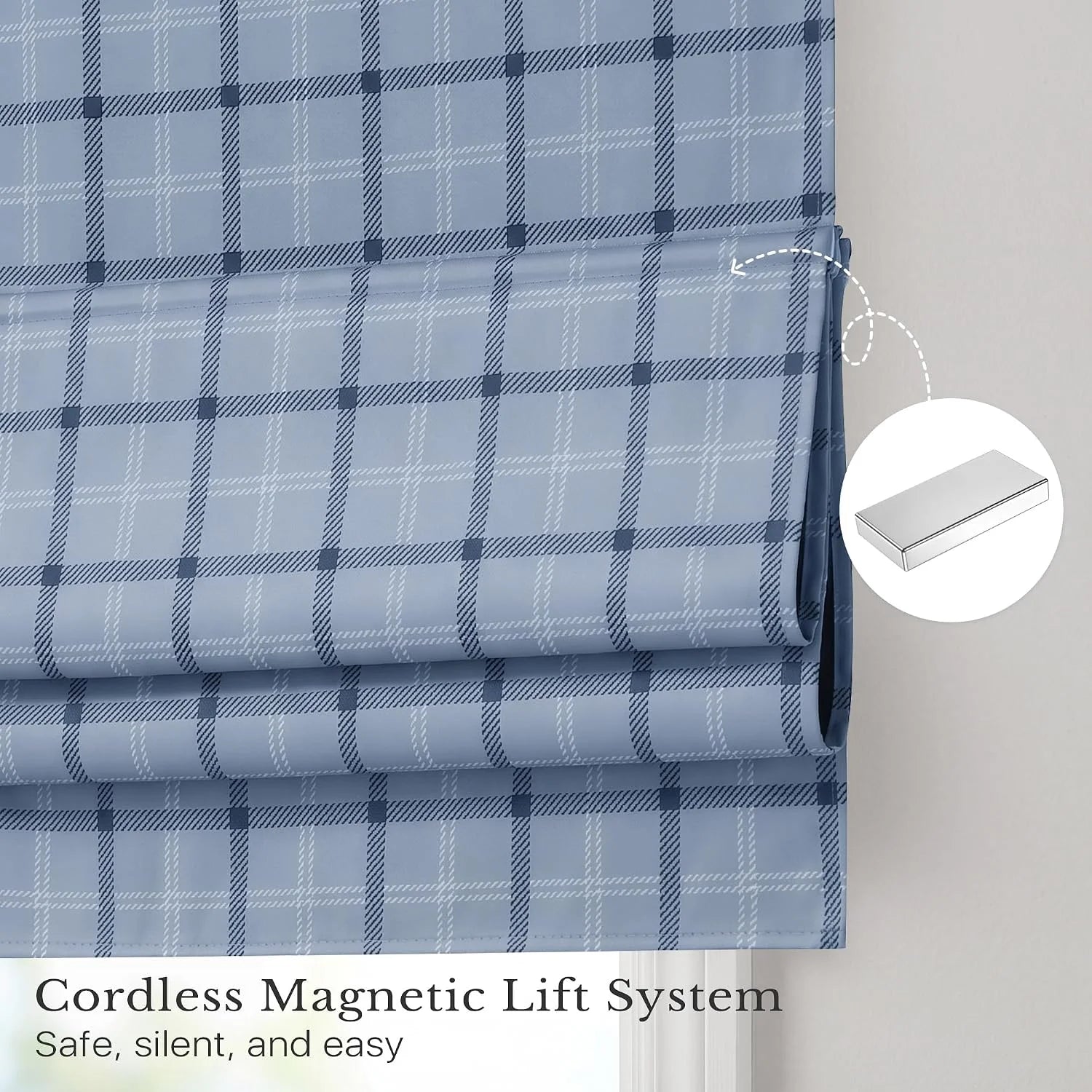 Light blue plaid cordless Roman shade with magnetic lift system on a window