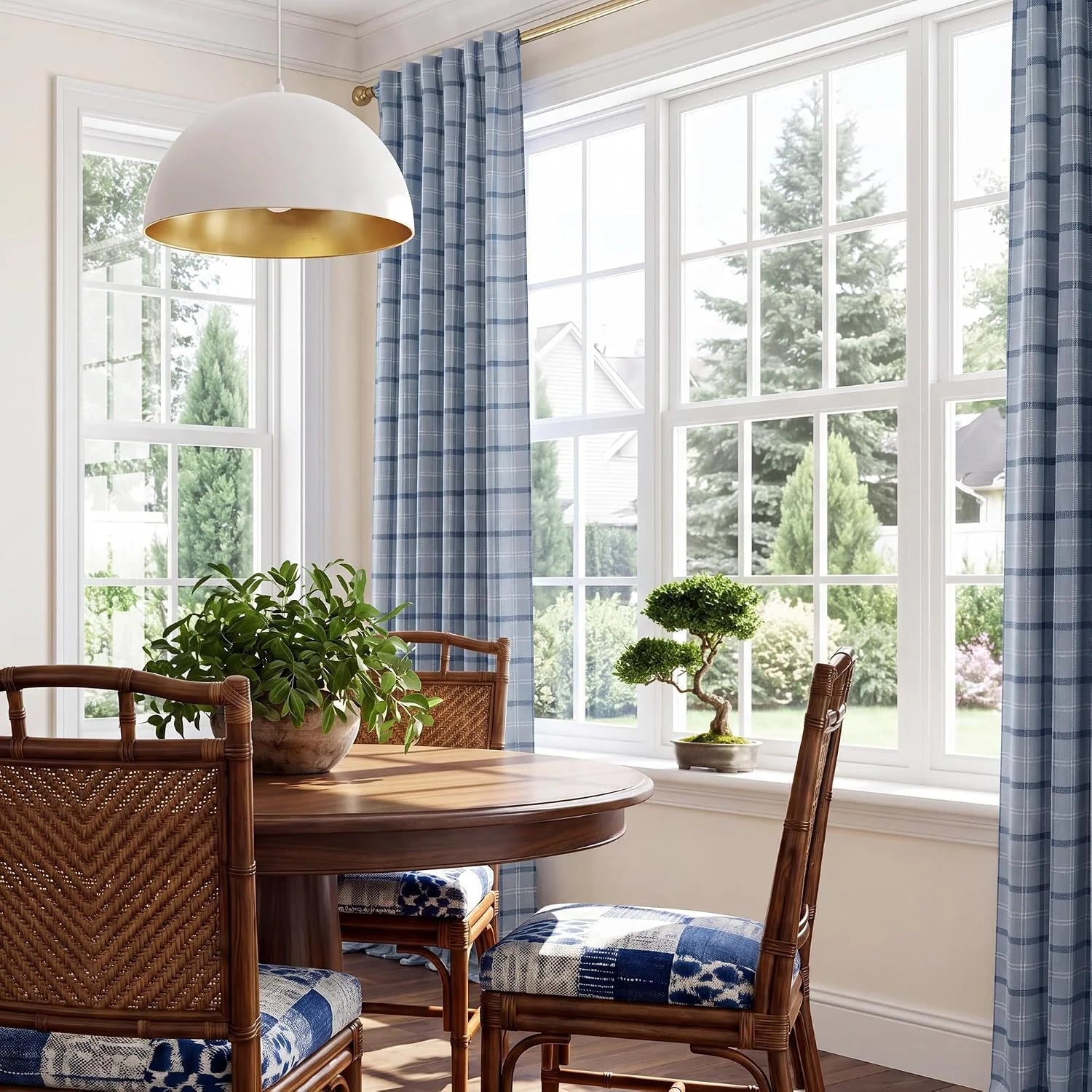 Blue plaid curtains framing tall windows in a bright coastal-style dining room