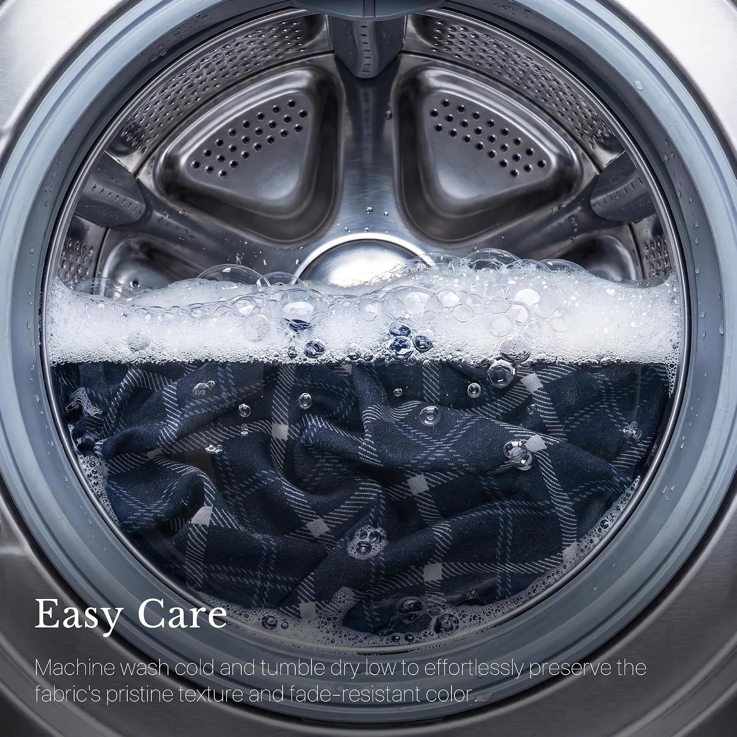 Blue plaid fabric washing in a front-load machine with suds, highlighting easy care