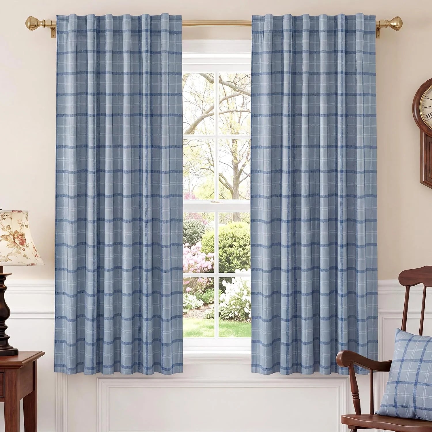 Light blue plaid curtains on a brass rod in a bright traditional room