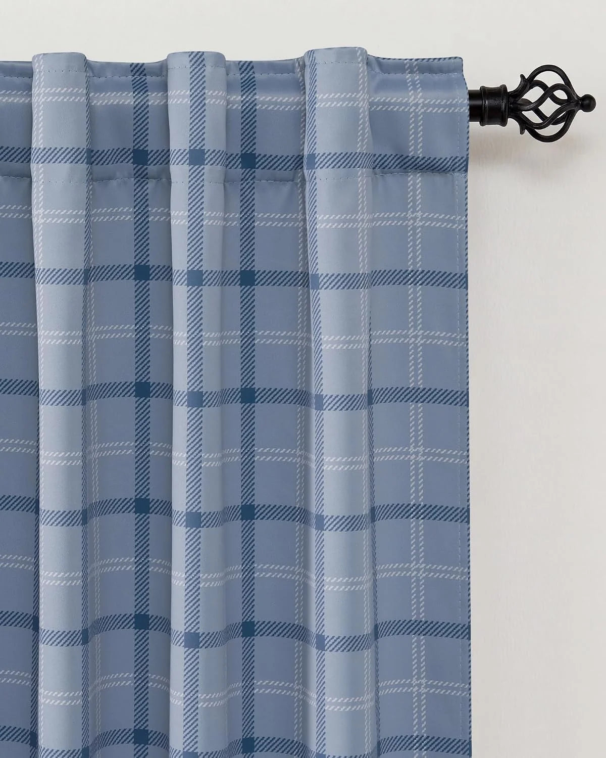 Light blue plaid curtain panel with rod pocket top on a black decorative curtain rod