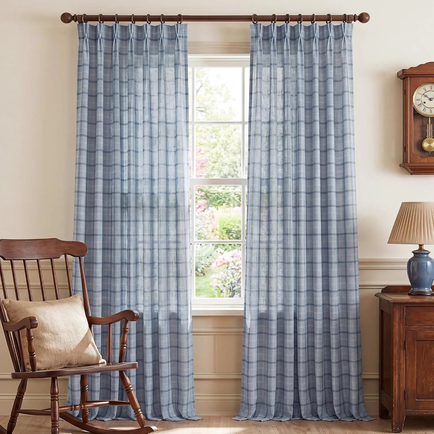 Light blue plaid sheer curtains on a wooden rod in a traditional room