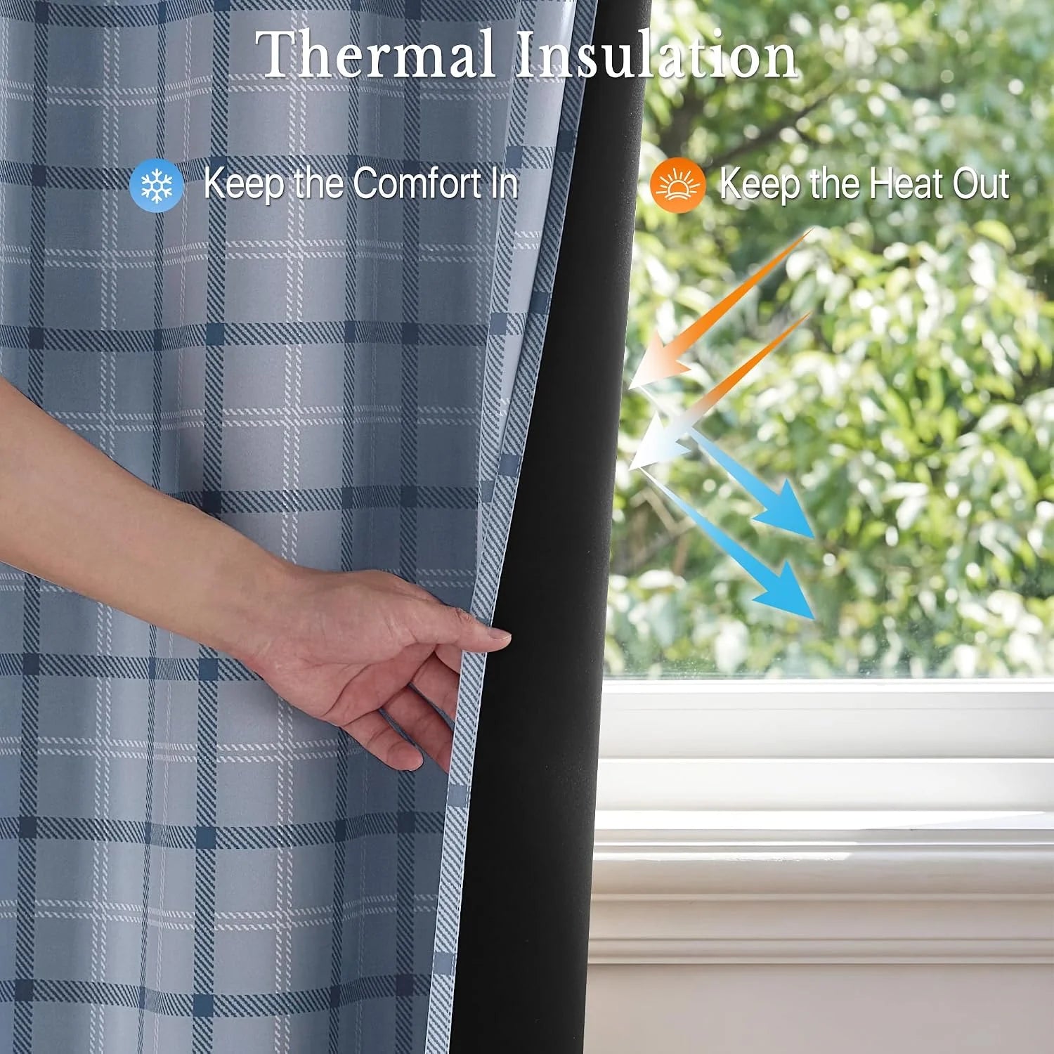 Hand holding blue plaid thermal blackout curtain with black lining by a sunny window