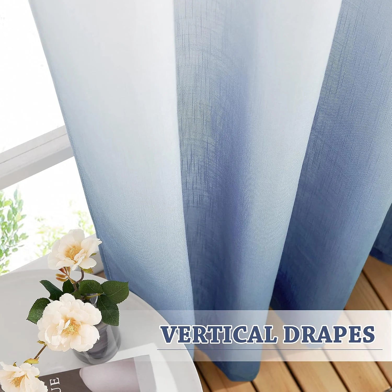Blue sheer linen-look curtains hanging in soft vertical drapes by a bright window
