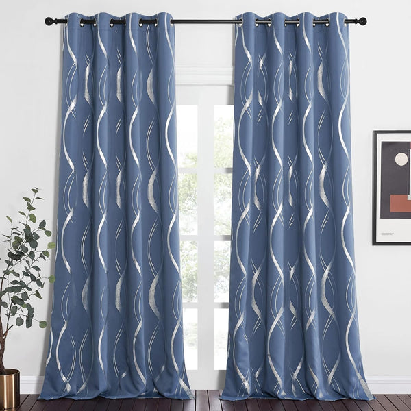 Modern slate blue grommet top curtains with shimmering silver wavy geometric pattern hanging by a window.