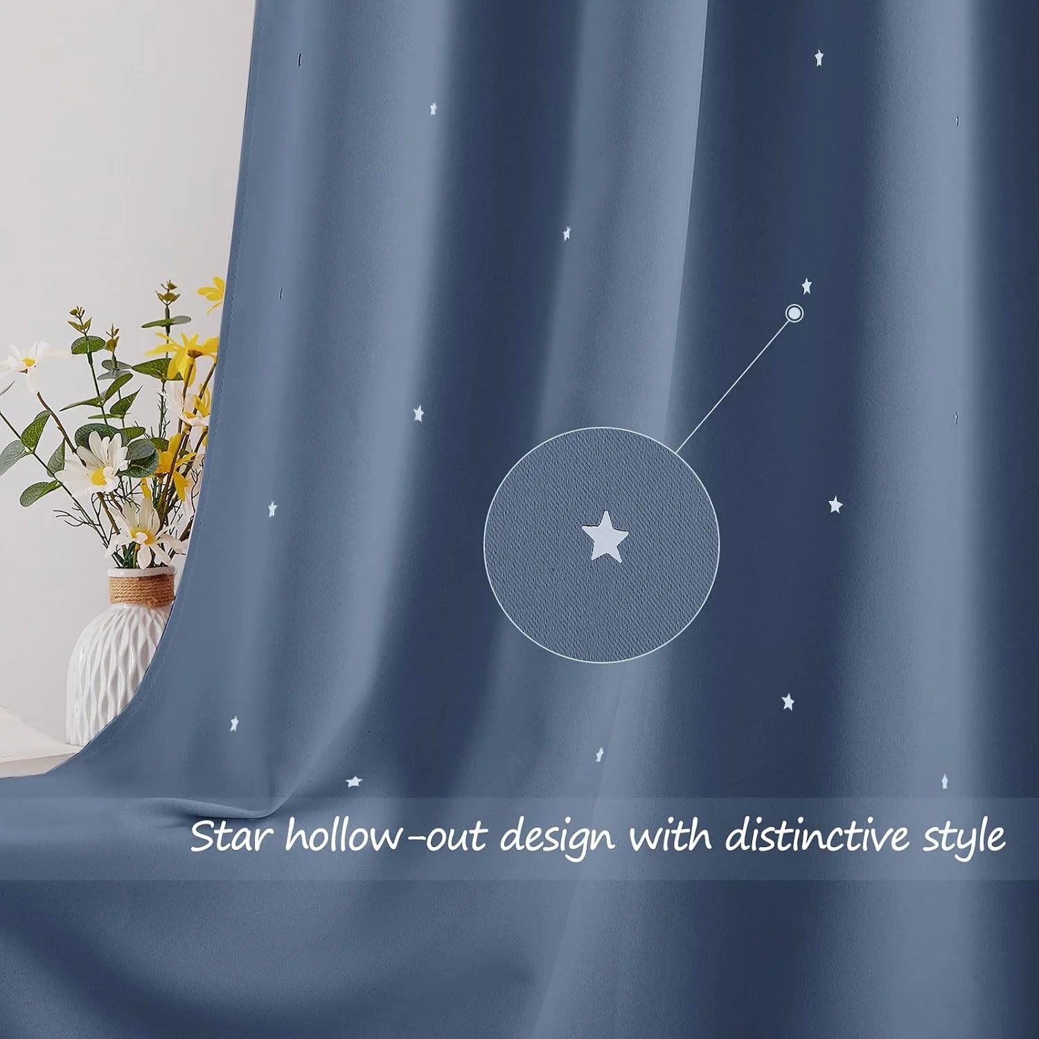 Blue curtain fabric with white star cutout pattern beside a vase of flowers