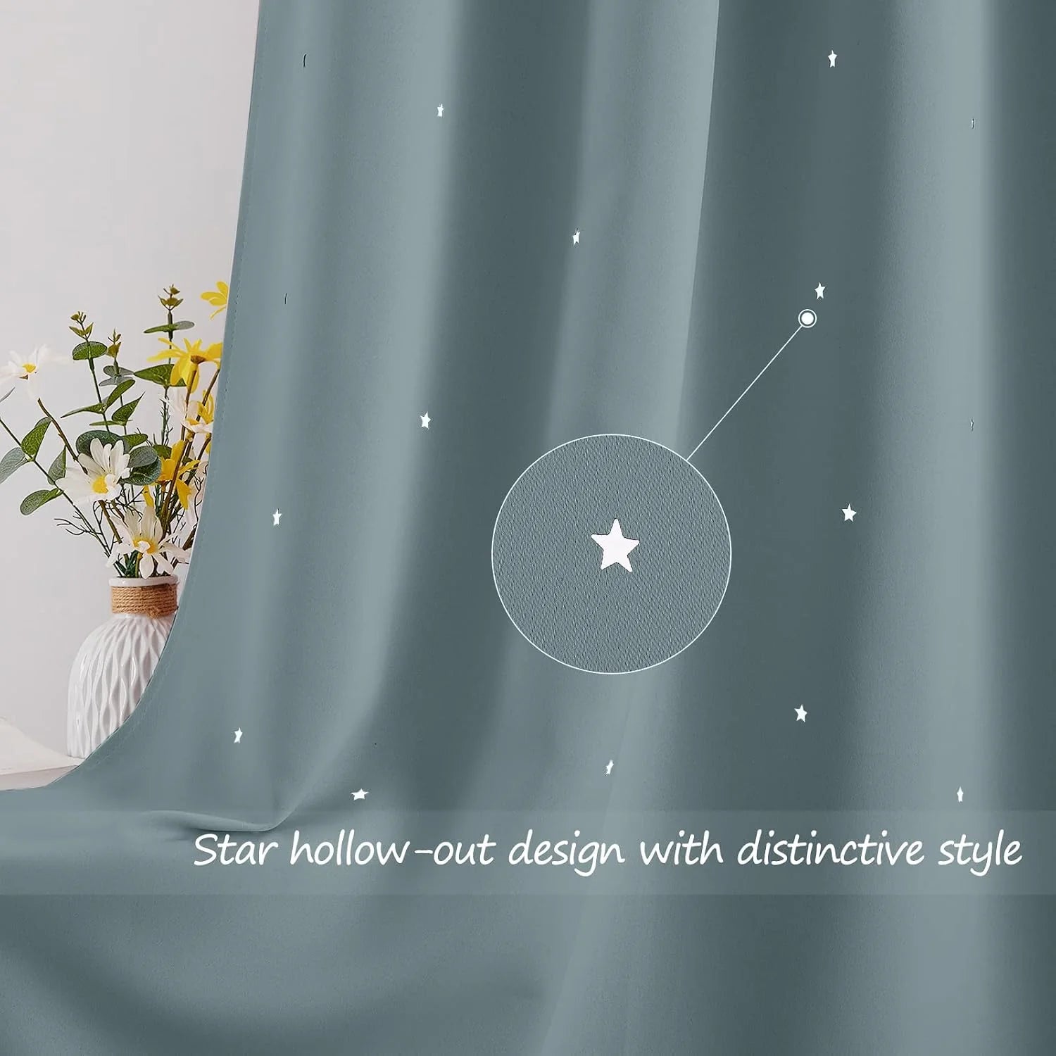 Soft blue curtain with small star cutout details beside a white vase of flowers