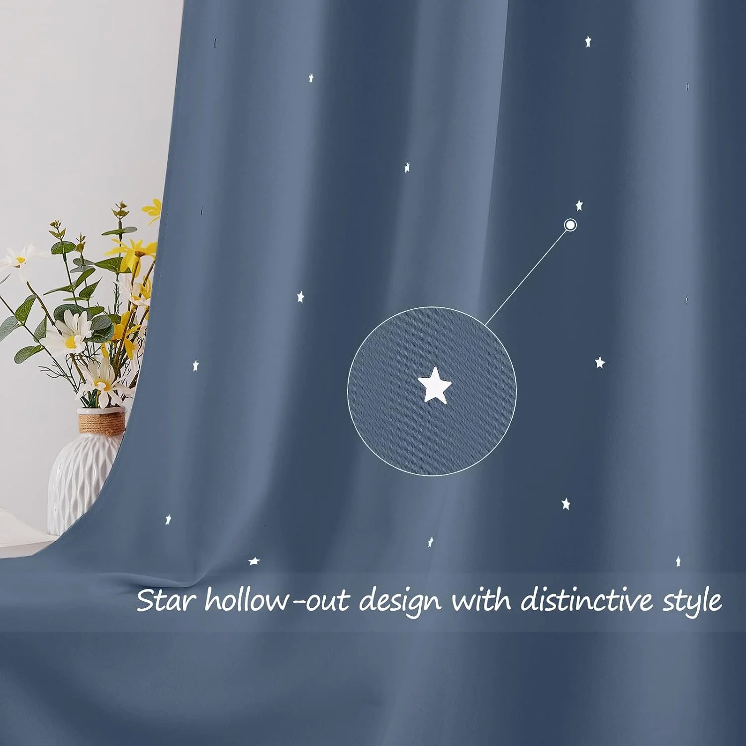 Blue curtain with small star cutout pattern draped beside a vase of flowers