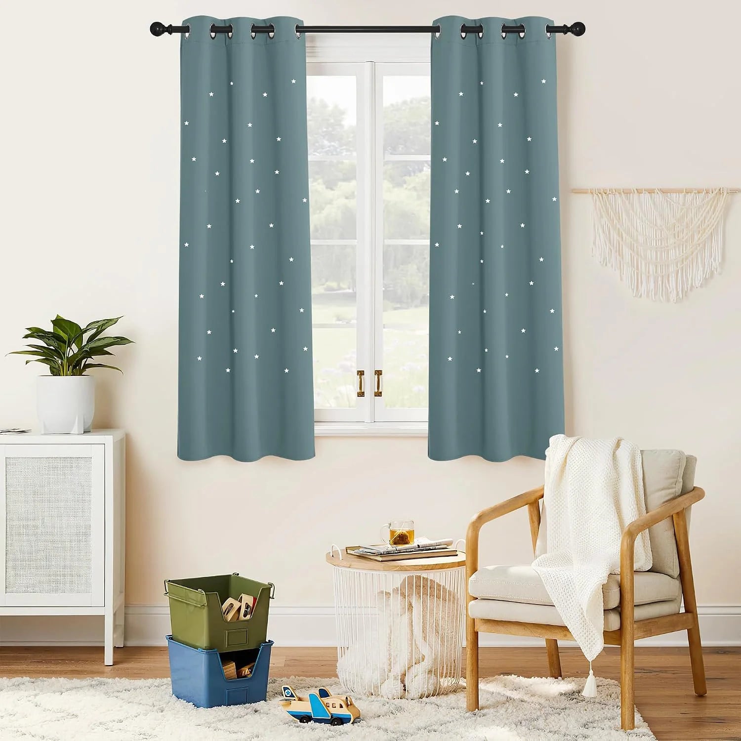 Dusty blue curtains with white star pattern and black grommets in a cozy kids room