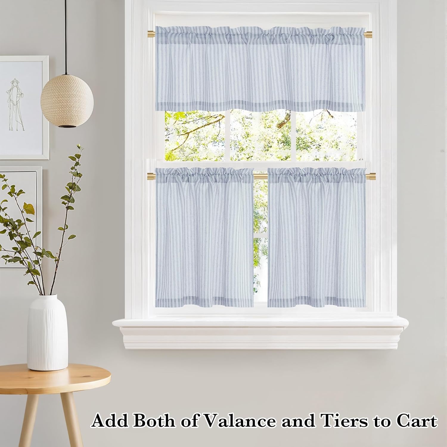 Light blue and white striped ruffled valance and tier curtains with rod pockets decorate a window.