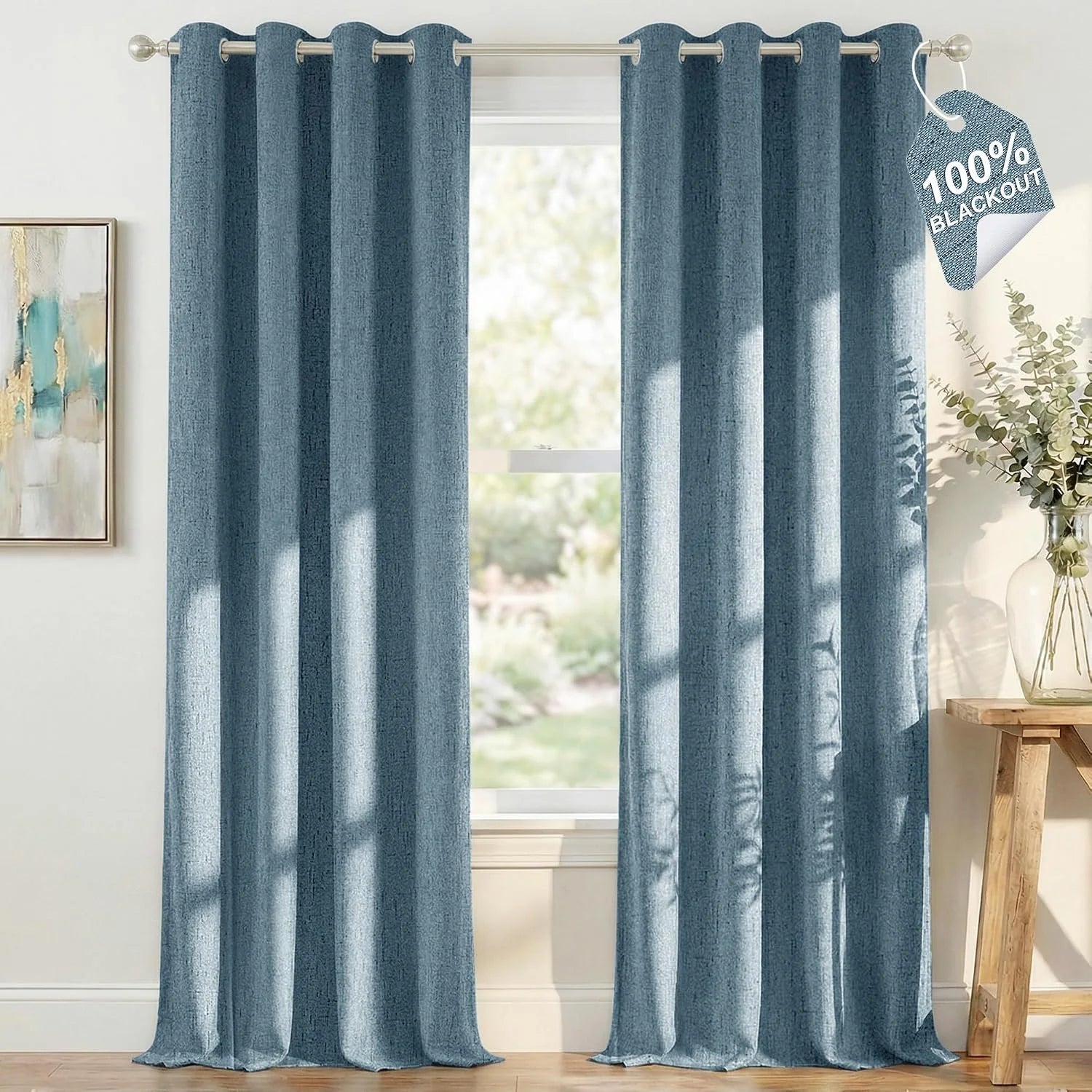 Blue textured blackout curtains with silver grommets hanging in a bright room