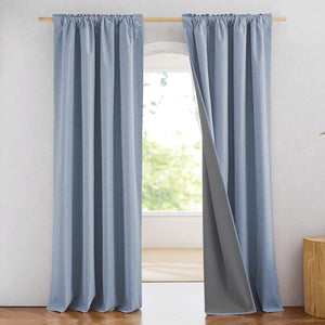 Light blue textured curtains with rod pocket top and dark grey blackout lining.
