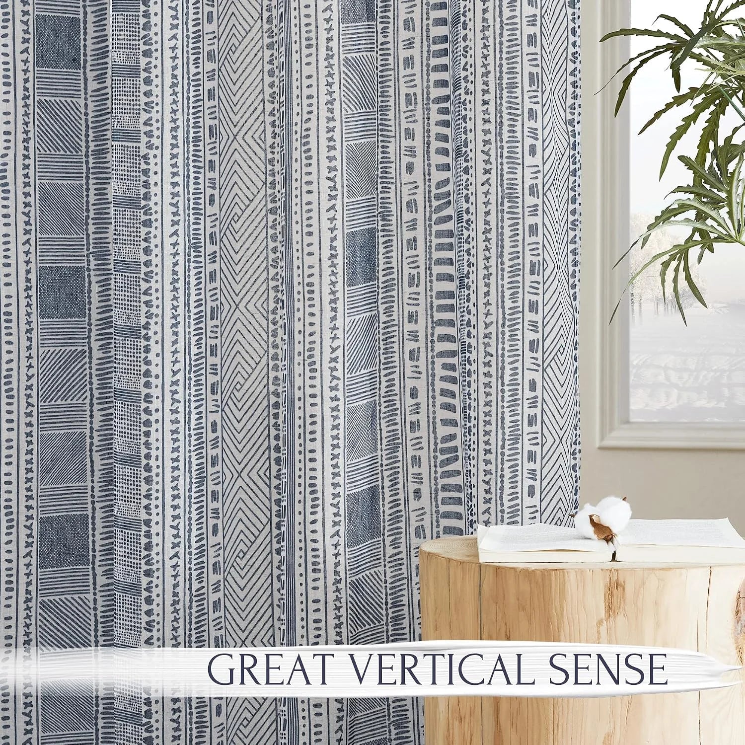 Blue and white tribal print curtain panel beside a window with wood side table