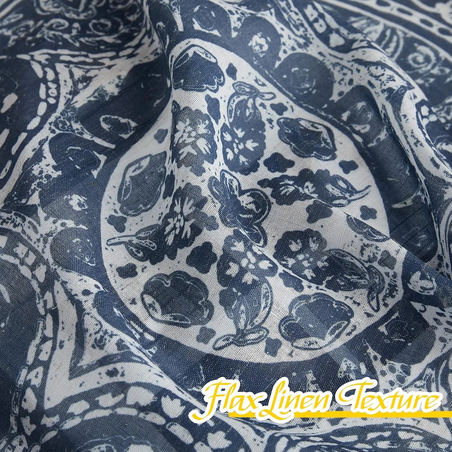 Blue and white flax linen fabric with floral paisley print shown in close-up folds