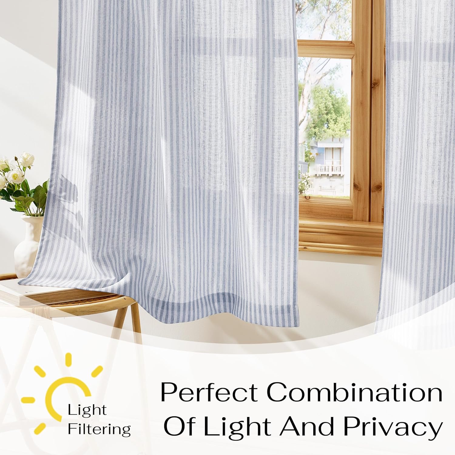 Light blue and white vertical striped linen curtains on a wooden window frame, diffusing natural light.